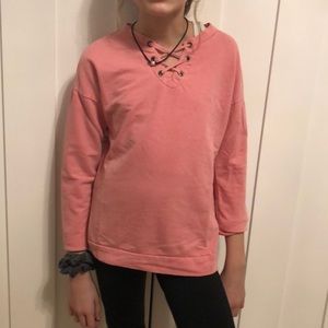 a pink long sleeve shirt with a crossed ties